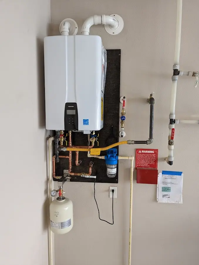 Professional plumber installing copper piping in a Lower Windsor home